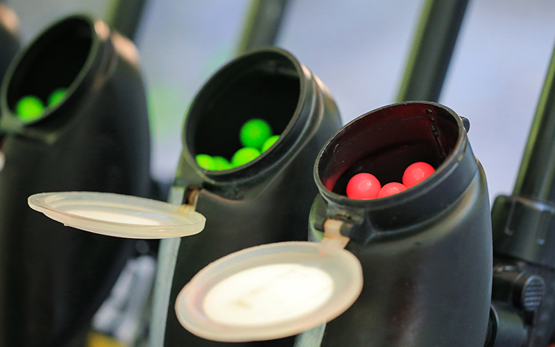 Paintball markers loaded with paintballs.