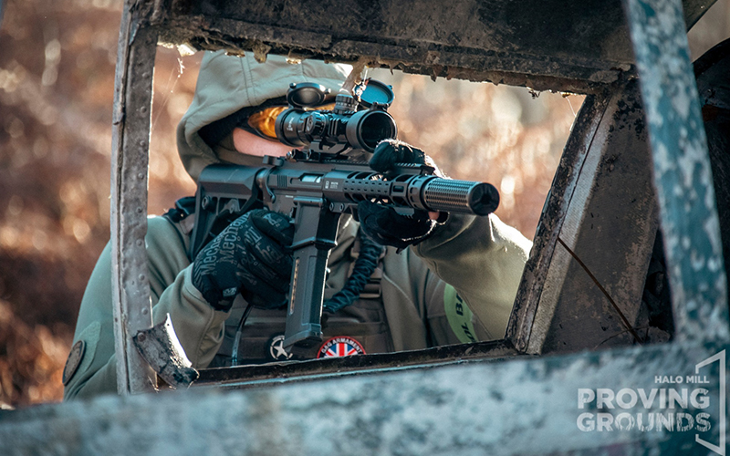 Airsofter aiming through a car window.