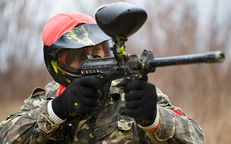 A paintballer aiming down their iron sights.
