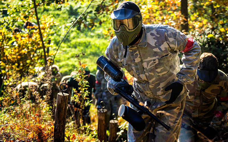 Paintballers traversing up a hill together.