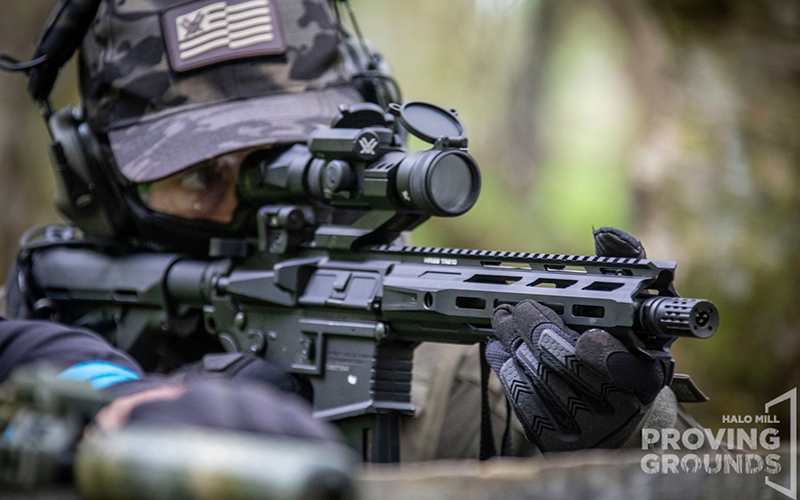 A tactical Airsofter aiming down sights.
