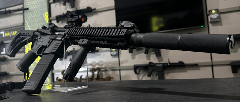 An Airsoft replica with an array of tactical accessories.