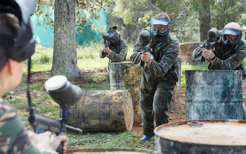 A group of paintballers advancing towards their opponents.