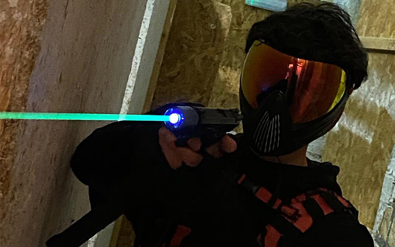 An Airsofter shooting a tracer BB out of his pistol